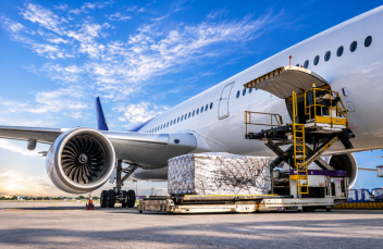 Cargo loader packing international removals shipment into a cargo plane for fast overseas relocation and moving services.